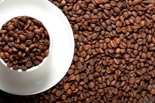 White coffee mug filled with coffee beans. High quality photo