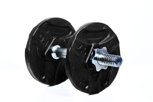 Metal dumbbell on a white insulated background. High quality photo