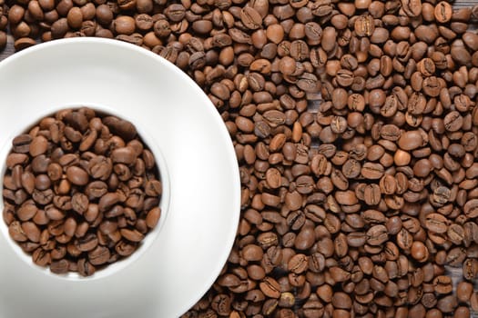 White coffee mug filled with coffee beans. High quality photo