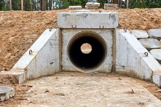 concrete pipe under the road for water drainage. High quality photo