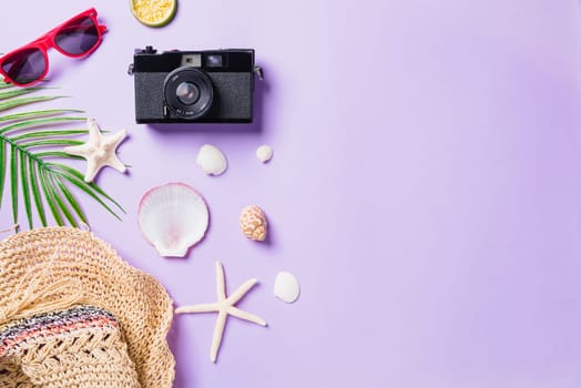 Top view flat lay mockup of camera films, airplane, sunglasses, starfish beach traveler accessories isolated on a purple background with copy space, Business trip, and vacation summer travel concept