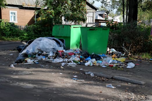 metal garbage cans are in a pile of garbage. High quality photo