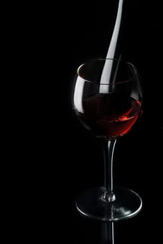 Glass of red wine on black background