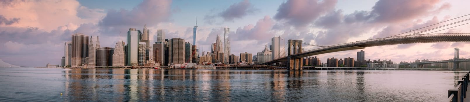 Panoramic view of New York City skyline with urban skyscrapers at sunset, USA.