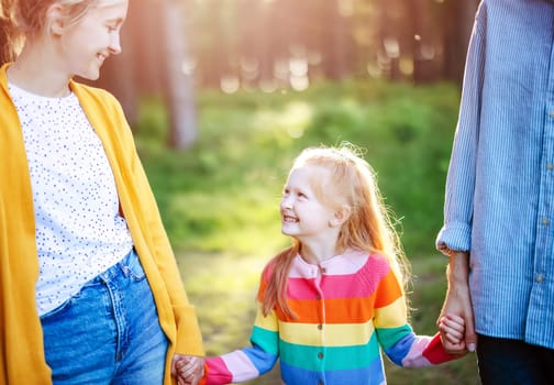 Happy family in the summer in natural park. Concept of the family relationships, helping and supporting.