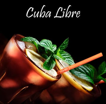 Cuba Libre cocktail on rustic wooden background