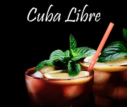 Cuba Libre cocktail on rustic wooden background