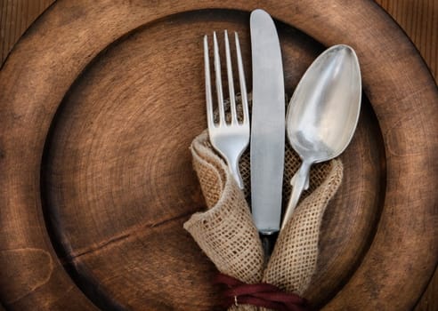 Vintage silverware on rustick wooden plate
