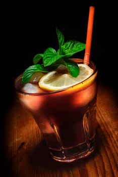 Cuba Libre cocktail on rustic wooden background