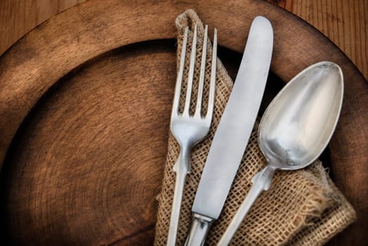 Vintage silverware on rustick wooden plate