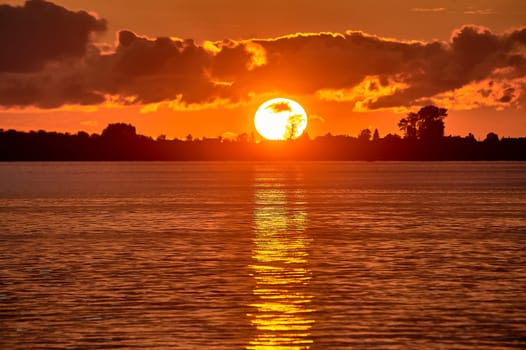 Sunset on the river, big sun. High quality photo