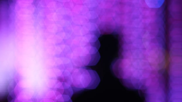 Blurry silhouette man with bokeh, festival lighting  background