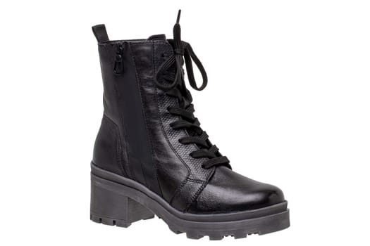 Womens boots and shoes. Closeup of a single elegant black leather winter boots. Latest trends of winter shoe fashion for girls isolated on white background. Macro.