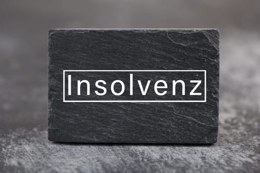 The word insolvency is standing in german language on a sign, bankrupt through lockdown, pandemic covid-19