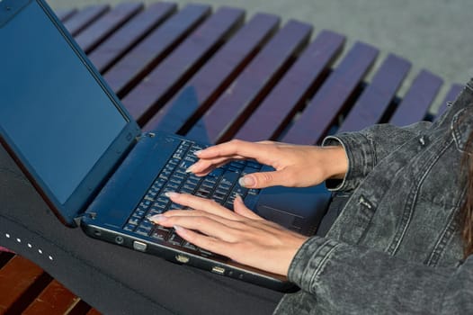 Female hands typing laptop keyboard close up. High quality photo