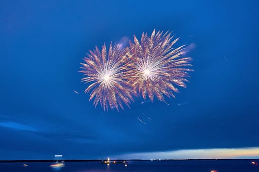 Colorful fireworks on the black sky background. High quality photo