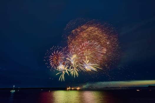 Colorful fireworks on the black sky background. High quality photo