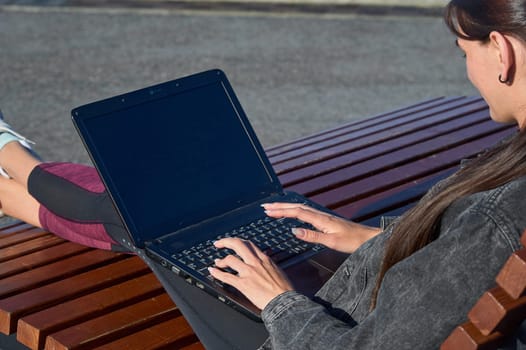 Female hands typing laptop keyboard close up. High quality photo