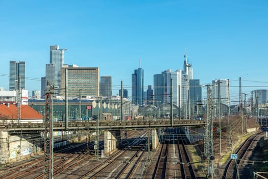 Frankfurt, Germany - Jan 11, 2020: view to central station Frankfurt with rails and Train an skyline of Frankfurt downtown.