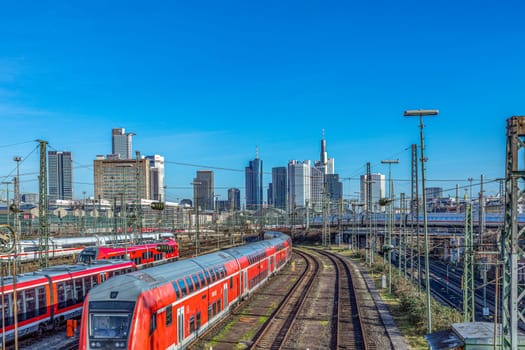 Frankfurt, Germany - Jan 10, 2020: view to central station Frankfurt with rails and Train an skyline of Frankfurt downtown.