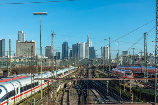 Frankfurt, Germany - Jan 11, 2020: view to central station Frankfurt with rails and Train an skyline of Frankfurt downtown.