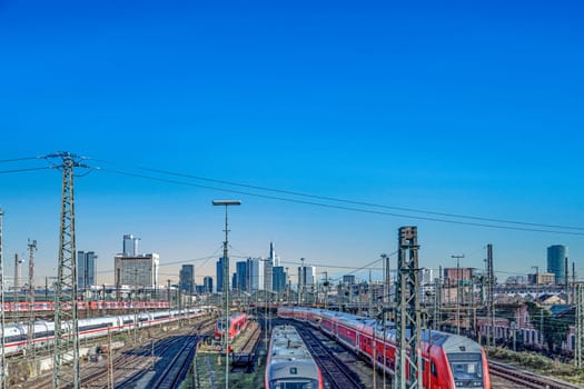Frankfurt, Germany - Jan 10, 2020: view to central station Frankfurt with rails and Train an skyline of Frankfurt downtown.