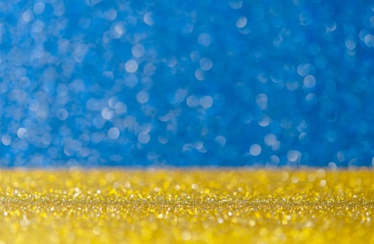 Golden glitter lights with abstract blue bokeh background