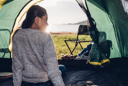 Back one woman inside view camping tent in summer at nature forest