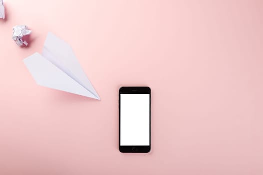 Paper plane letter document message. Top view mock up design of airplane travel and mobile phone, education or innovation origami plane with smartphone blank screen, isolated on pink background