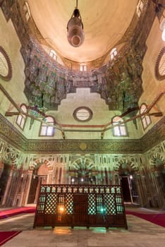 Cenotaph mediating mausoleum chamber at Mamluk era historical Mosque and Madrasa of Sultan Hassan with multicolored marble mosaic, and carved inscription of the Throne Verse, Cairo, Egypt