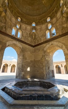 Interior of ablution fountain mediating courtyard of Ibn Tulun public historical Tulunid era mosque overlooking arched passages surrounding the courtyard, Sayyida Zaynab district, Cairo, Egypt