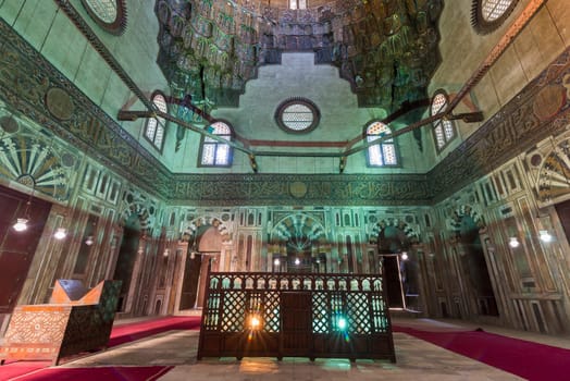 Cenotaph mediating mausoleum chamber at Mamluk era historical Mosque and Madrasa of Sultan Hassan with multicolored marble mosaic, and carved inscription of the Throne Verse, Cairo, Egypt
