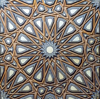 Closeup of wooden arabesque decorations tongue and groove assembled, inlaid with ivory and ebony, on door of minbar of historic public Mosque of Al Rifai, Old Cairo, Egypt