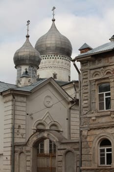 old church with domes next to the building, an example of the classical architecture of Russia in the 19th century