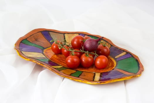 vegetables on a clay plate - white background