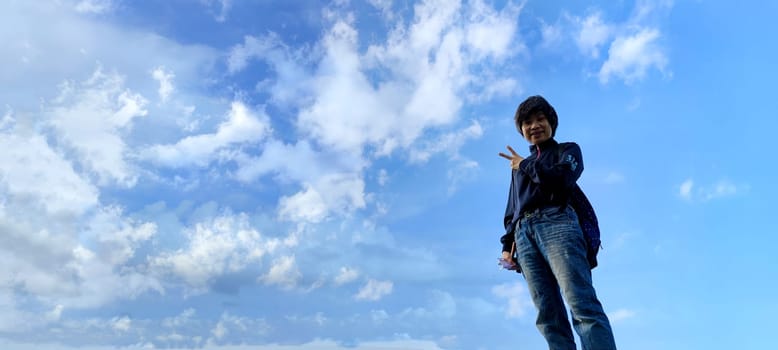 The girl in a jump. Young beautiful woman posing against blue sky bright sunny weather