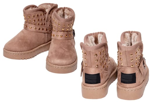 Childrens winter boots. Close-up of two pairs elegant brown suede leather winter boots lined with fur. Girls winter shoe fashion newest trends isolated on a white background. Macro photograph.