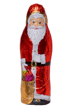 Chocolate Santa isolated. Close-up of a cheerful wrapped chocolate Father Christmas or the good Saint Nicholas figure isolated on a white background. Macro photography.