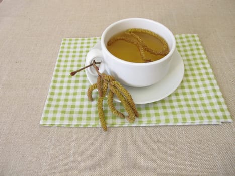 Herbal tea with hazel catkins, hazel flowers from hazel shrub