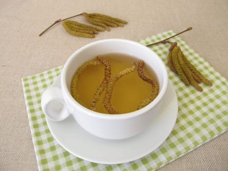 Herbal tea with hazel catkins, hazel flowers from hazel shrub