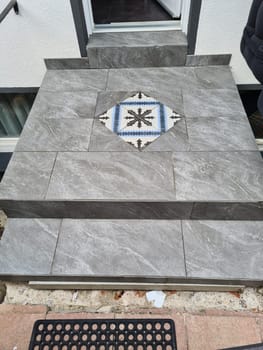 Laying ceramic floor tiles - man hands closeup