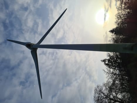 Wind turbine in the evening sun landscape. Alternative energy concept