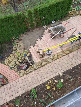 Worker laying pavement rocks
