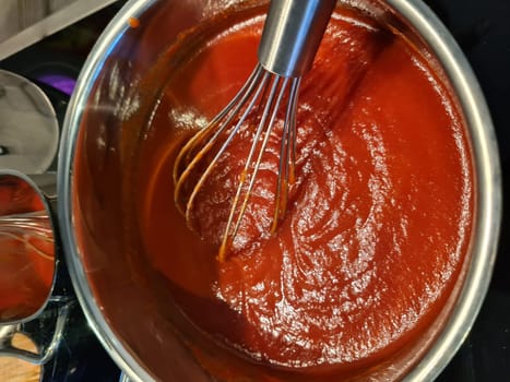 Tomato sauce with garlic and basil in a wooden bowl closeup. horizontal view from above