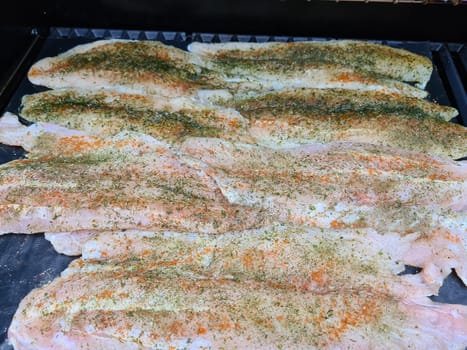 Professional chef cooking fish on a barbeque