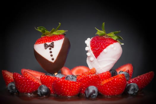 Confectionery luxury art trend marriage strawberries bridal couple embellishment, blueberries and frosting cream. Food symbol of love.