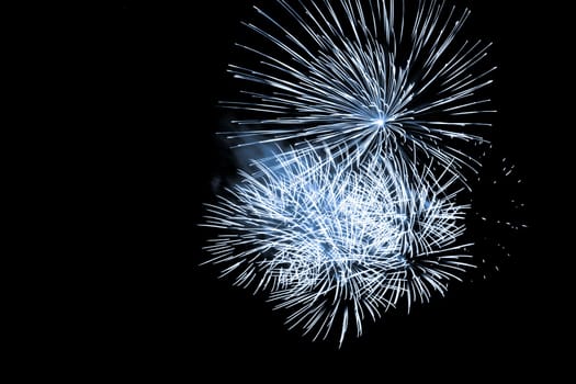 Premium entertainment magic star firework at e.g. New Years Eve or Independence Day party celebration. Black dark night background.