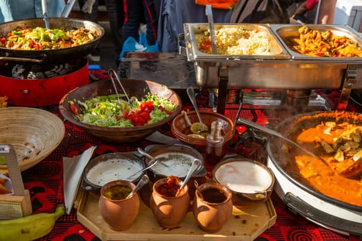 Cheff cooking fusion international cusine on street stall on international street food festival of Odprta kuhna, Open kitchen event, in Ljubljana, Slovenia.