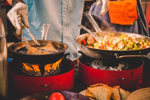 Cheff cooking fusion international cusine on street stall on international street food festival of Odprta kuhna, Open kitchen event, in Ljubljana, Slovenia.