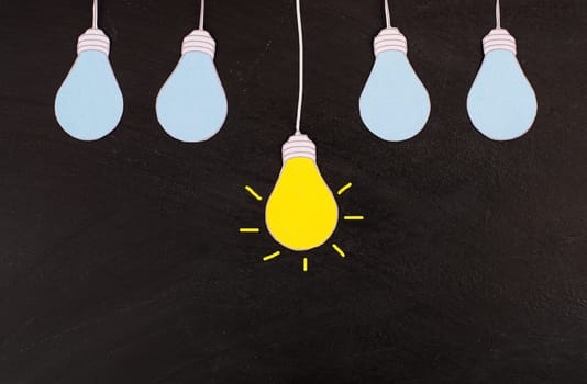 Standing out from the crowd, having a new idea, light bulb concept, be different, leadership
